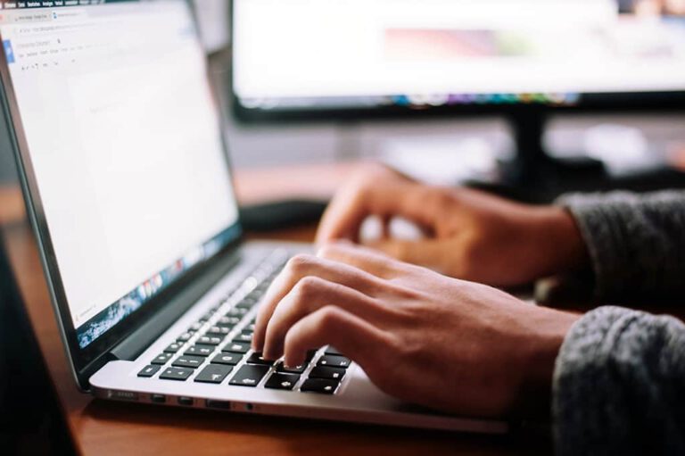 man typing on a computer keyboard
